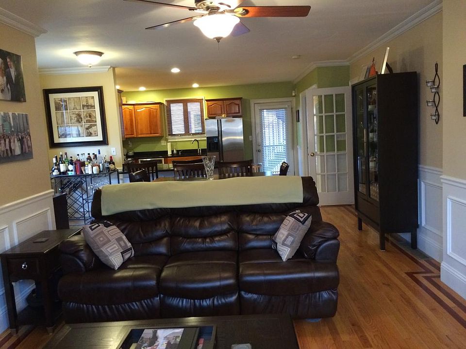 Main living area in foreground, dining area & kitchen in rear