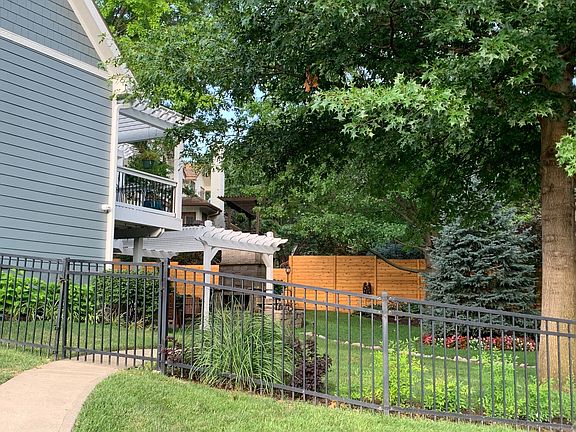Parklike setting in fenced backyard with fireplace & pergola