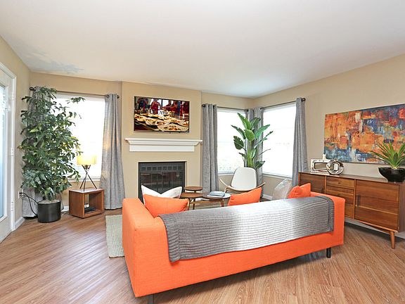 Spacious living room with wood-style plank flooring.