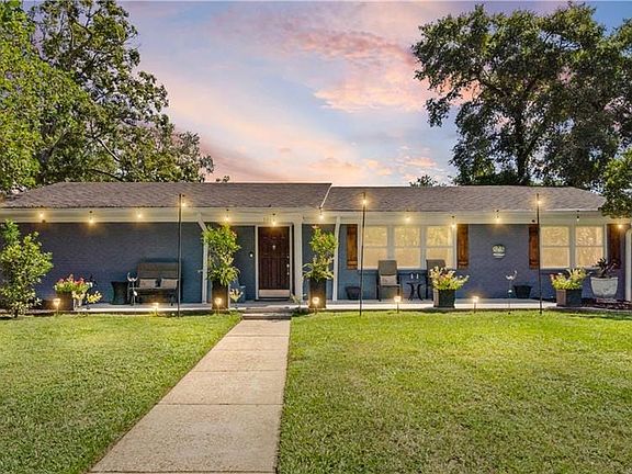 Property entrance with covered porch and brick siding