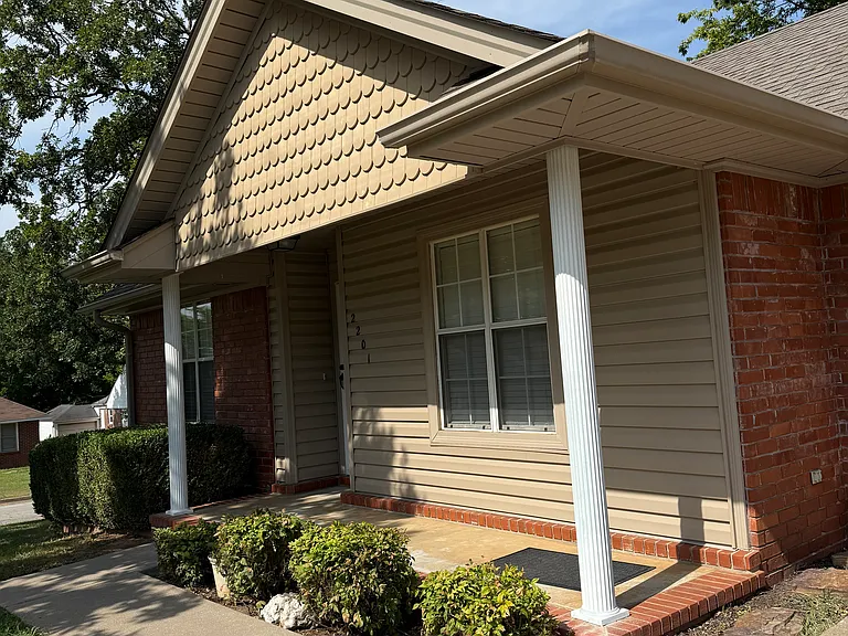 Front porch. Recessed front door includes glass storm door.