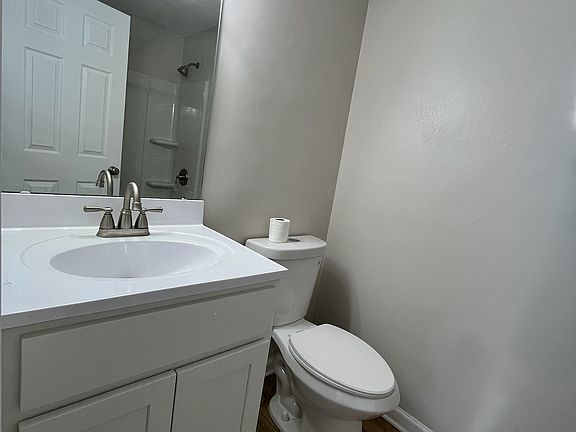 View the other side of the gorgeous, upgraded, full bathroom with new everything: vanity, mirror, lights, toilet, floors, plumbing, towel bars, and fan!