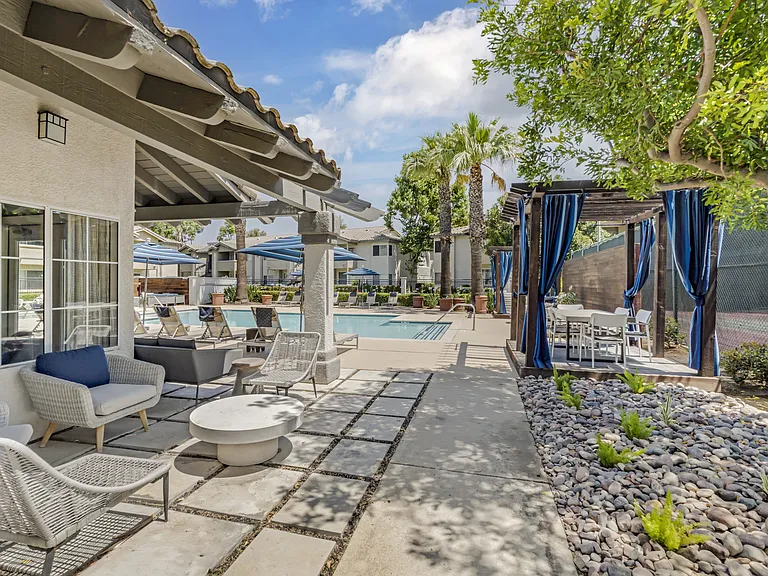 Right beside The Summit's pool deck, a shaded lounge area offers the perfect place to cool off and unwind, all while enjoying a relaxing view of the tennis court just steps away.