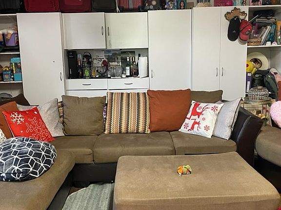 Garage seating area with cupboards and lot of storage