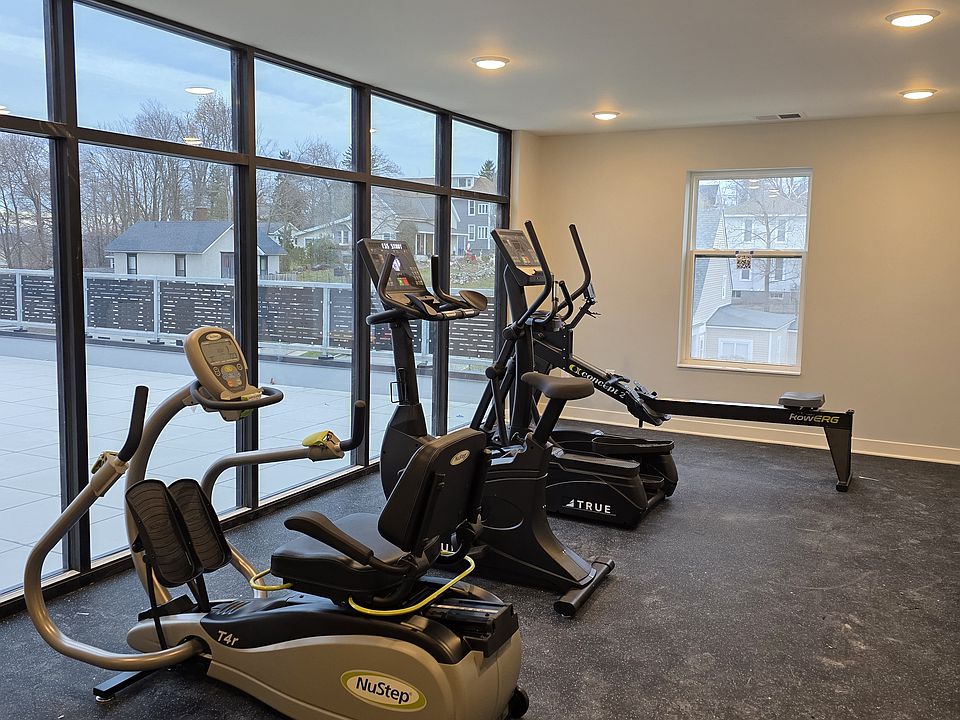 Fitness room with NuStep, upright bike, elliptical trainer and rowing.