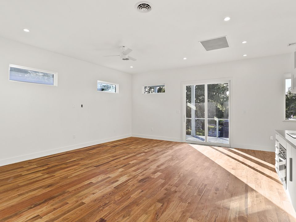 Large living room with wall mounted TV outlet.