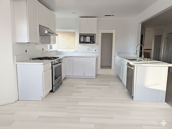 Completely renovated kitchen featuring new appliances and modern finishes