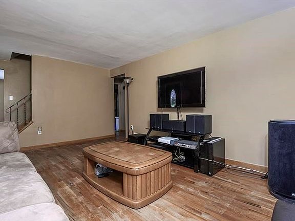 Living Room: Spacious living room with newer windows, marble window ledges and hardwood floor. Newer front door with leaded glass.
