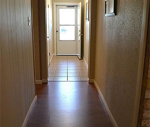  Entry hallway with wood laminate flooring.