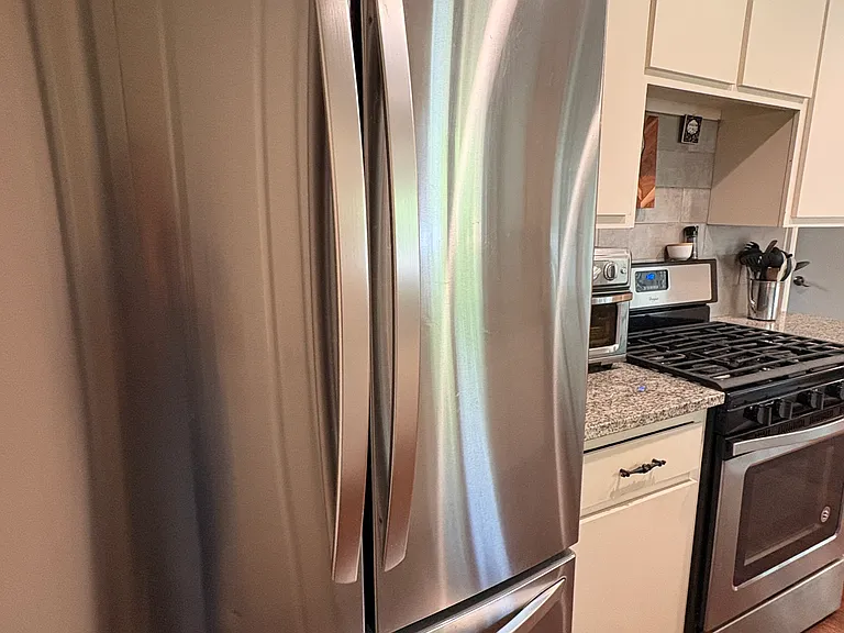 Galley style kitchen with an updated LG fridge.