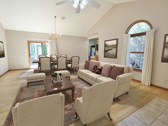 Dining room / living room area with hardwood floors. NOTE: virtually edited furniture.