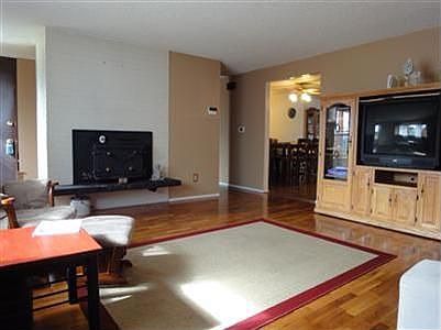Classic 1950's living room with oak floors and wood burning fireplace