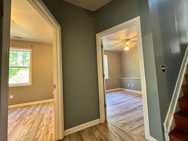 Once downstairs, the hardwood floorings will lead you directly to three spacious bedrooms. (The one not pictured in this frame is behind the camera)