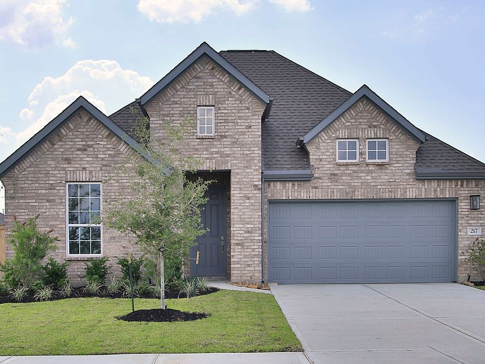 Exquisite brick facade with gabled roof and manicured garden in Willow at River Ranch. A touch of lu