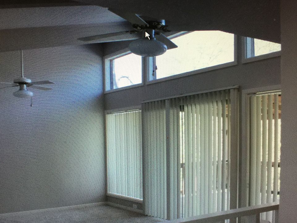 Living area has tall ceilings and lots of light.