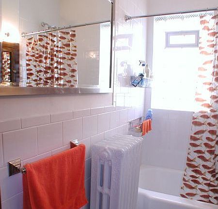 Totally renovated the bathroom with gleaming subway tiles, glass block window, new plumbing, new pedestal sink, 