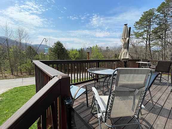 Spacious front deck with spectacular views to enjoy sunsets, abundance of birds and seating for evening cookouts and happy hour.