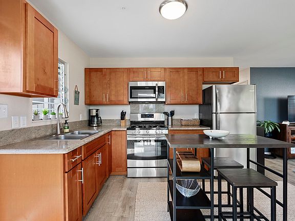 kitchen with granite countertops, stainless steel appliances, gas range