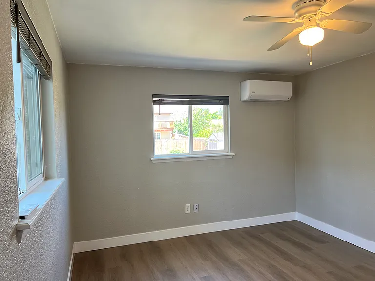 Bright primary bed with 2 windows, new pet-friendly LVP, fresh paint & custom zoned mini-split AC/heat.