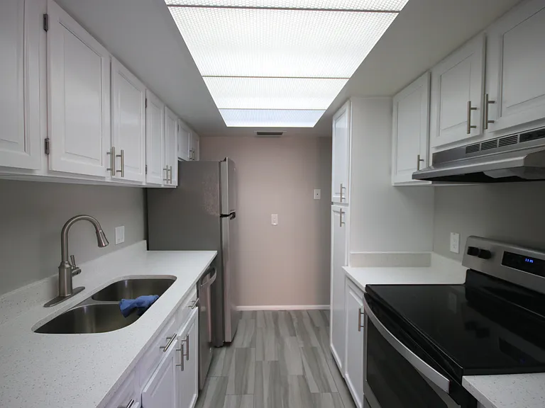 A view of your double sink, dishwasher, refrigerator, range and oven and your ample cabinet space. Note. Landlord is purchasing a counter top microwave prior to your move-in.