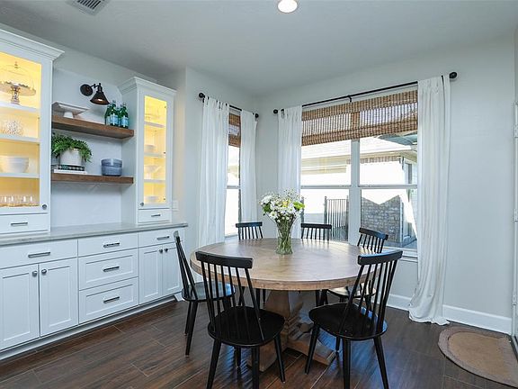 Breakfast room with wood like tile floors and custom buffets cabinet