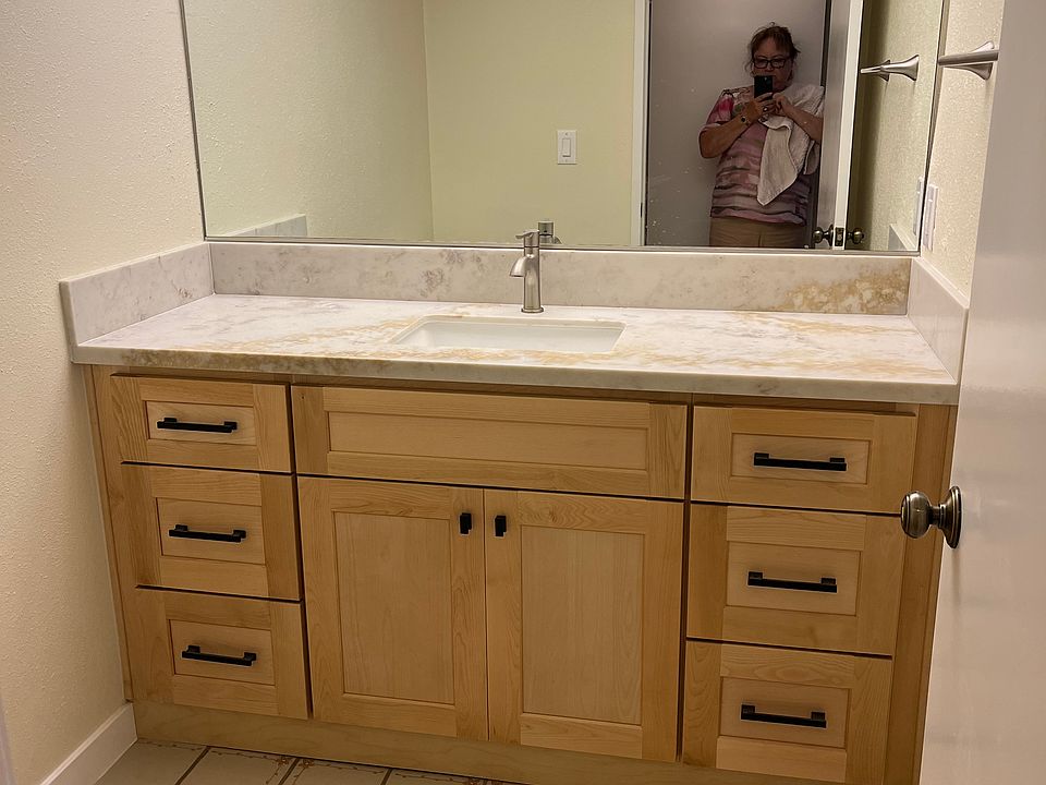 Bathroom on the first floor with new quartz countertops, new cabinets and new mirror