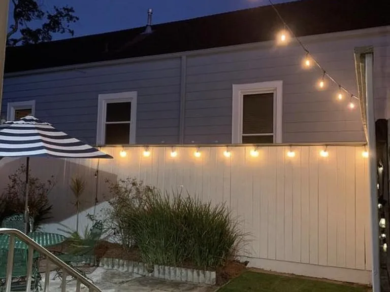 Enjoy the backyard with string lights and a seven foot privacy fence.
