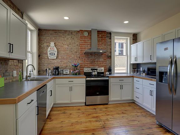 Kitchen with dishes, bakeware, pots and appliances