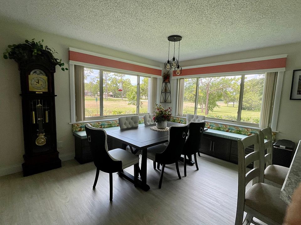 The west, northwest panoramic view, that includes the golf course, is filled with natural light. The dining room chairs are plush; bench seating and storage are a bonus!