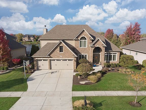 Located on a premium lot with scenic pond view~New upgraded garage doors & exterior lighting!