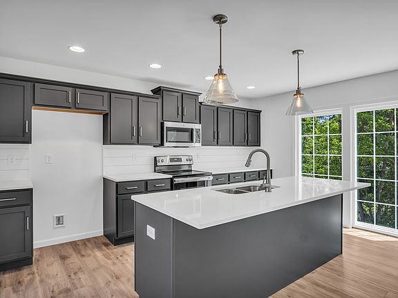 Kitchen with center island of the Charlotte Model from Garman Builders
