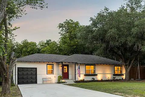 Front of house with large driveway that can fit 4 cars