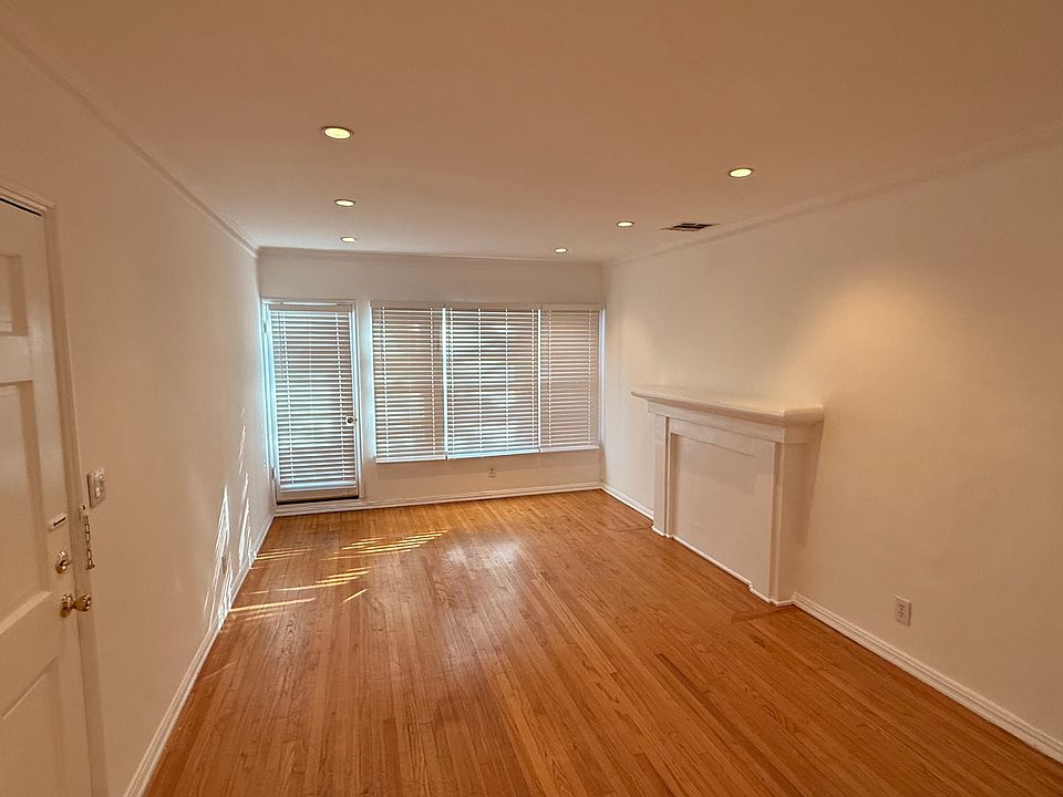 Living room with recessed lights and hardwood floors.