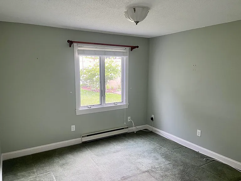 Office or Den, and 11' x 11' space with view of trees.