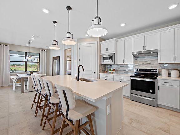 Open kitchen with decorative backsplash and large center island