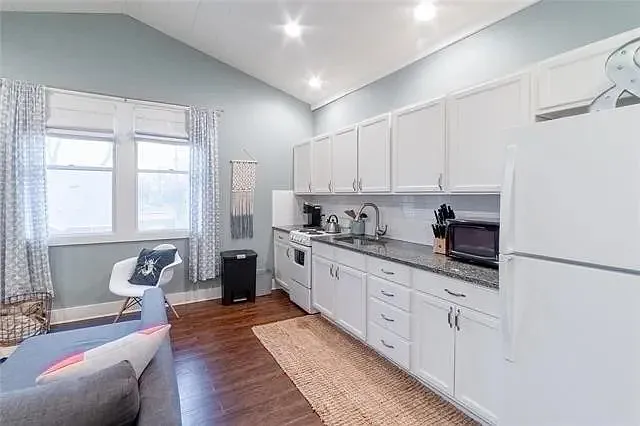 Full kitchenette with stainless steel appliances, including a microwave, stove, and refrigerator for all your cooking needs.
