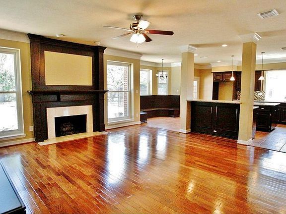 Hardwood floors and gas log fireplace in the open floor plan Living Room