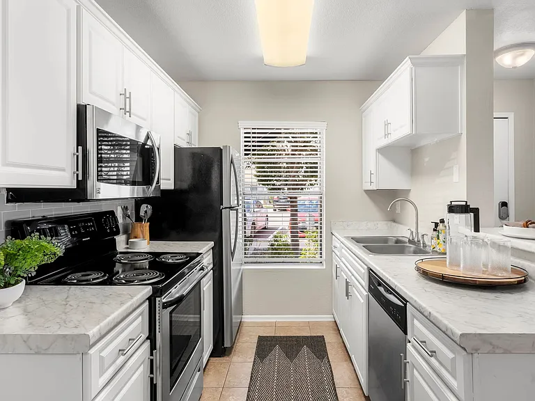 Behold our beautifully remodeled, chef-inspired kitchens adorned with opulent marble-like countertops and stainless-steel enchantment.