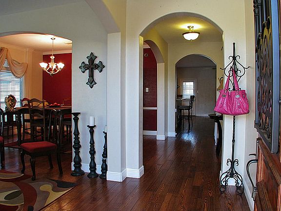 The entry foyer runs past both formal an ends in the kitchen/den area.  Check out the beautiful wood floors!