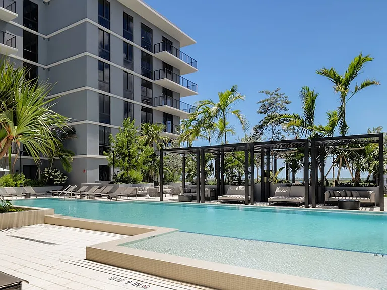 Resort-style pool and sundeck with cabanas
