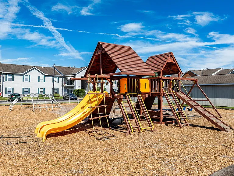 Dooley's Orchard community playground with a yellow slide and a play area.