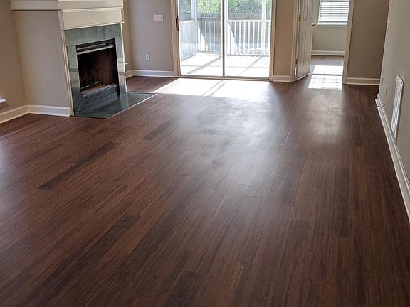That all-new awesome kitchen opens into this marble wood-burning fireplace living area with access to your private screened-in porch and large fenced-in, newly-sodded backyard.
