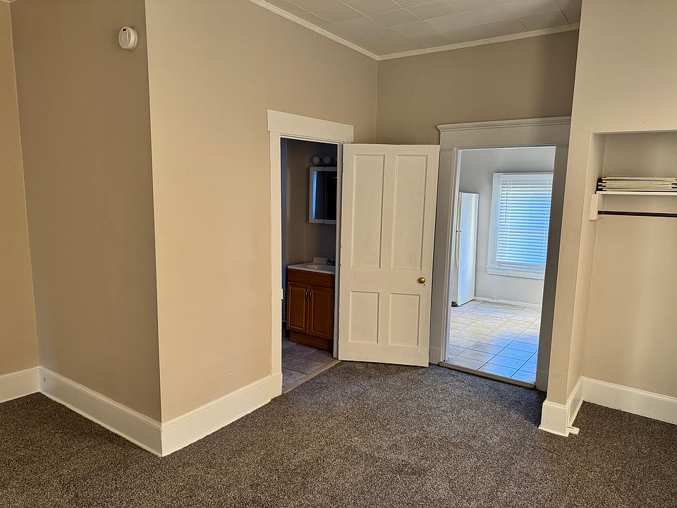 looking into the kitchen and bathroom from the bedroom. 2 closets, one is a small walk in.