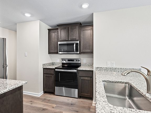 The kitchen has beautiful wood cabinetry.