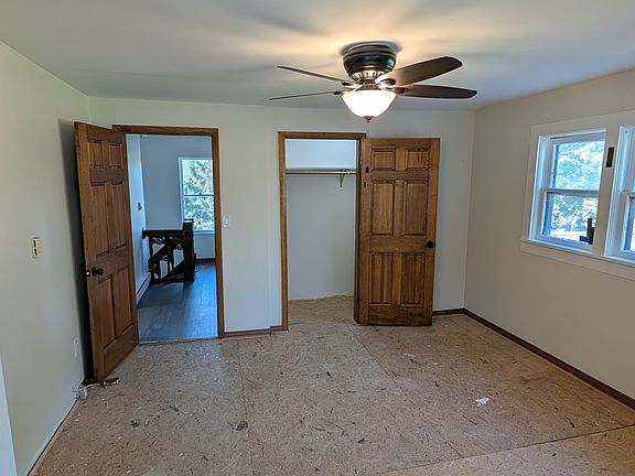 Bedroom with walk in closet. Carpet is being installed.