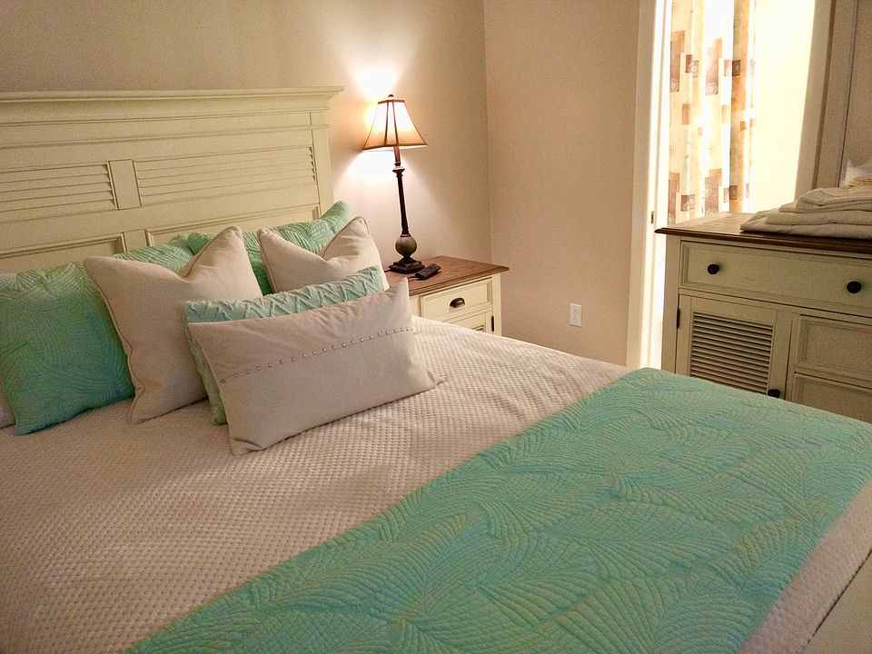 Each bedroom features a dresser and closet providing guests with plenty of clothing storage.