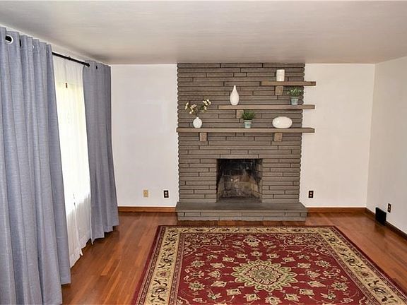 Living room with stone wood burning fireplace for those cold nights.