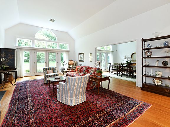 Living room with fireplace open to dining room