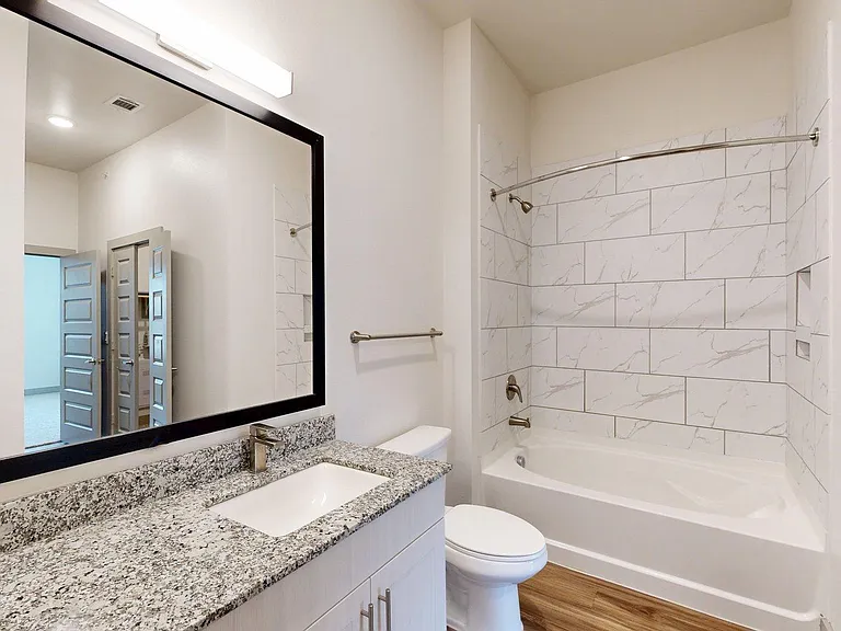 Apartment Bathroom with large soaking tub and Tile Flooring.