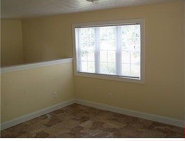  Formal dining room with tile floor painted in neutral tones. 